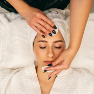 A woman receiving a soothing facial massage at Zen spa for relaxation and skincare.